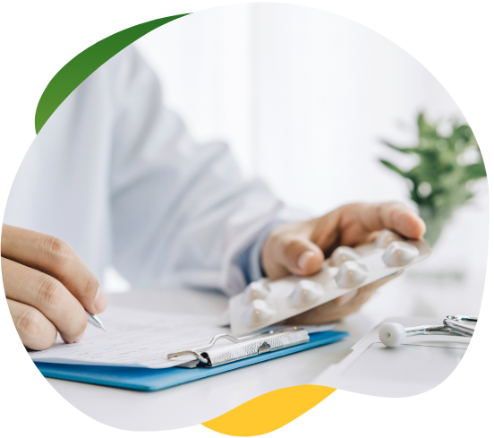 Doctor’s hands in front of a desk with documents and medicine