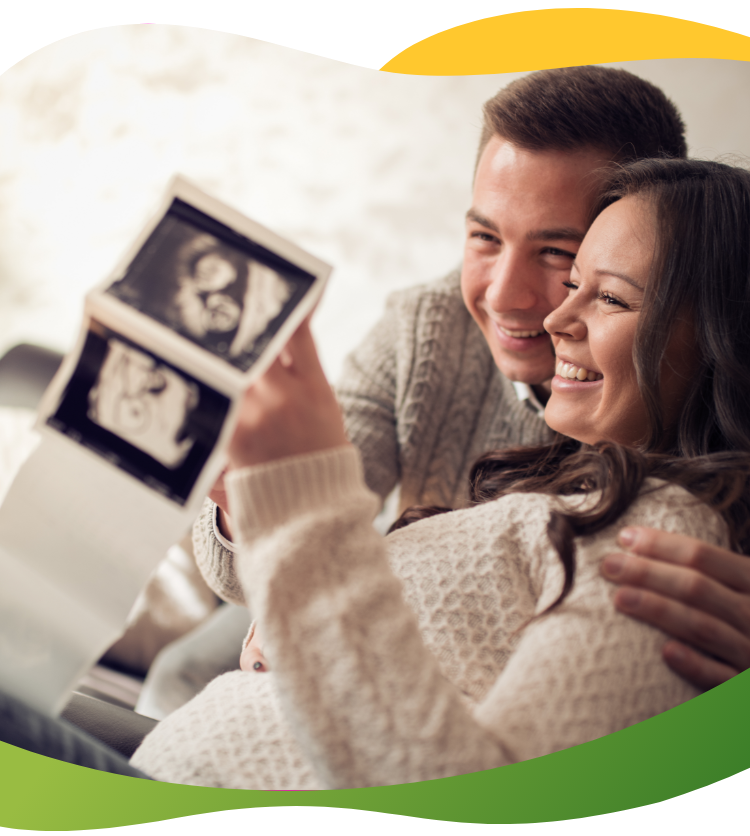 Parents-to be look at ultrasound images of the baby